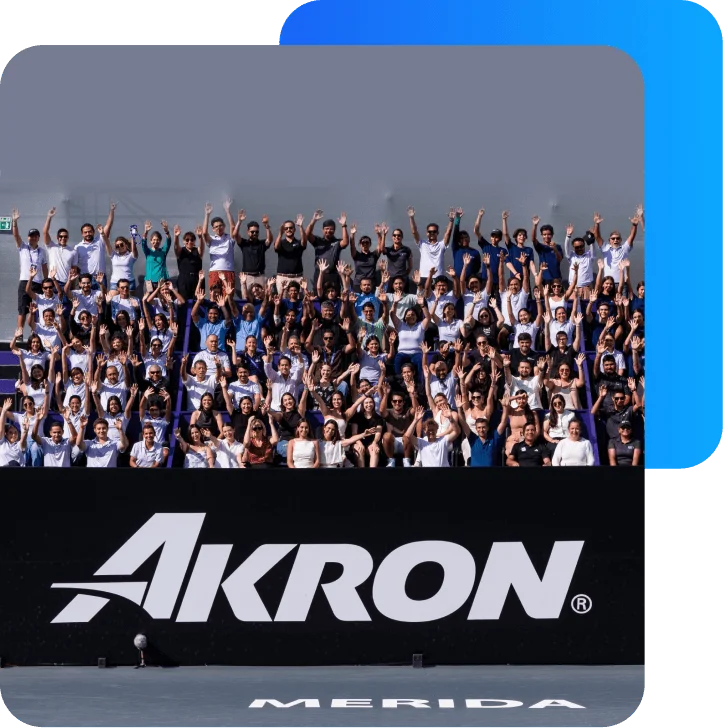 Large group of attendees waving at the Akron WTA Mérida Open tennis tournament stands.
