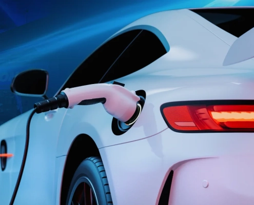 auto con enfoque en primer plano siendo cargado mediante conector elétrico