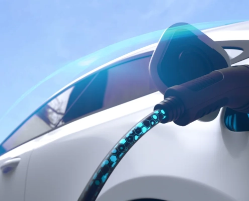 auto con enfoque en primer plano siendo cargado mediante conector elétrico